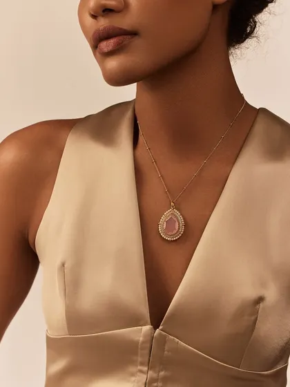 The Gulmohar Dusty Rose Chainette is an elegant and delicate necklace. It sits gracefully on the wearer, perfect for adding a subtle hint of color and sparkle to a simple outfit.