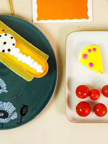A flatlay of beautifully designed plates, showcasing how different patterns and foods can be styled together.