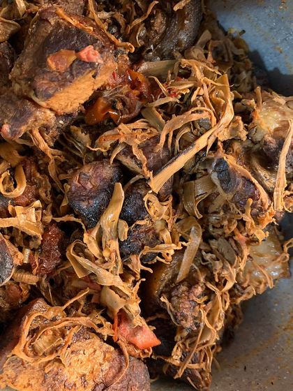 A dish of smoked pork with dried bamboo shoot, part of a larger meal.