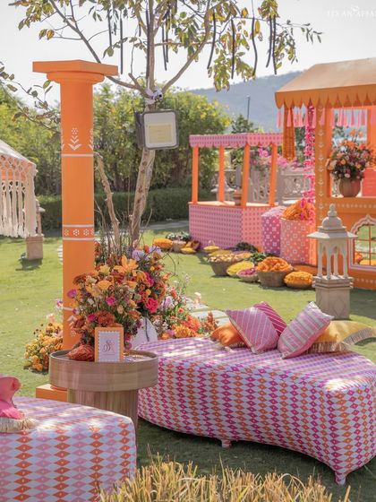 A lounge area with custom-printed geometric upholstery in pink and orange. The design mixes traditional elements with modern, comfortable furniture.