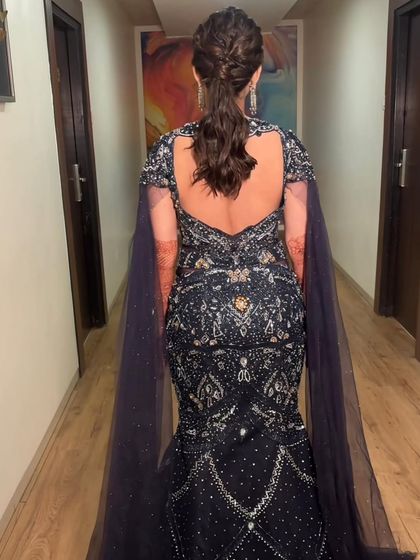 A detailed shot of the intricate hairstyle. A braided ponytail is a chic and modern choice for a cocktail or reception event.