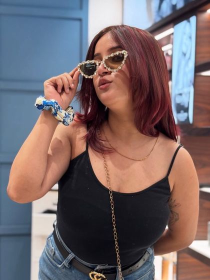 A client rocking her new bold red hair colour with confidence and style.