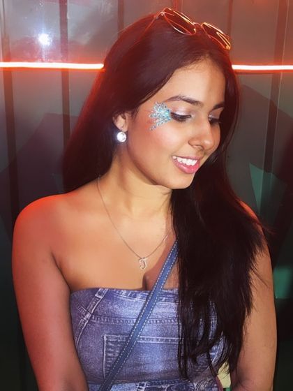 A soft dusting of blue and silver glitter on the cheek. This creates a dreamy, iridescent effect that's perfect for a party.