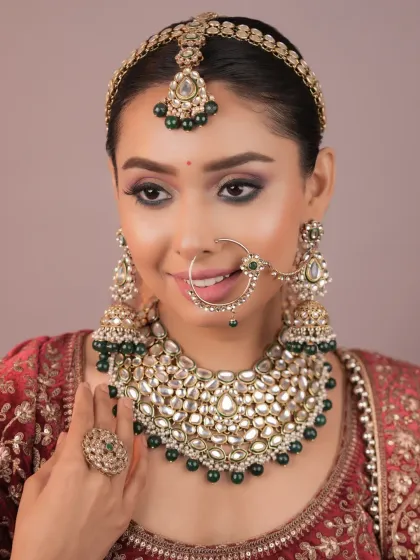 This look showcases the art of creating a complete, cohesive bridal appearance. You will learn how to select makeup tones that complement the outfit, jewelry, and accessories like the nath (nose ring).