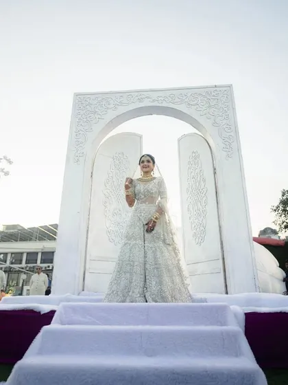 A grand, all-white carved entrance for the bride's walk down the aisle. This set a tone of pure elegance and royalty for the wedding ceremony.