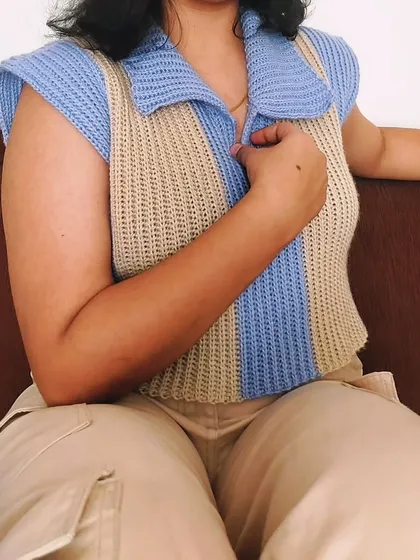 A relaxed, seated view of the Knit-Like Sweater Vest, showing its comfortable fit.