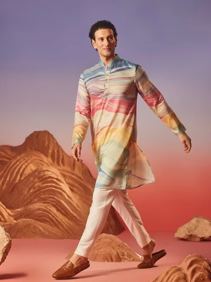 The 'Wave of Colors' silk kurta features a beautiful, abstract pattern reminiscent of a sunset. It is a piece of wearable art, perfect for a creative soul.
