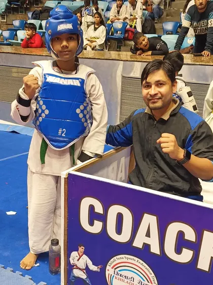 A female student ready to compete, with me in the coach's corner offering support.