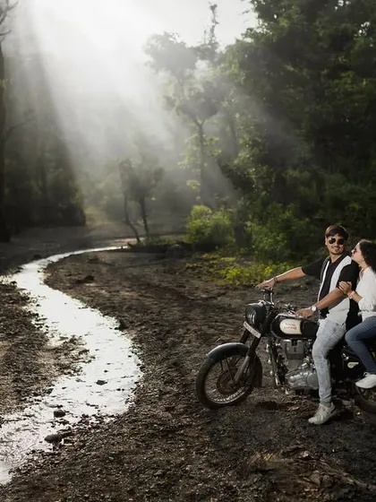 I love creating a moody, cinematic feel. Here, we used the misty forest roads of Uttarakhand and a classic motorcycle to capture a moment of adventure and romance, with dramatic light rays breaking through the trees.
