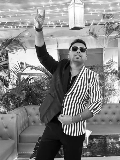 A black and white version of my rockstar pose. It highlights the sharp silhouette of the outfit and the dynamic energy I bring.