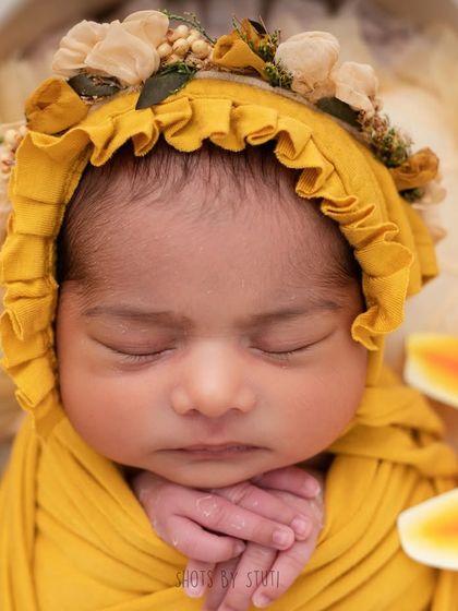 The bonnet frames her face so perfectly. I have a wide collection of handmade bonnets, headbands, and wraps to style your baby's session.