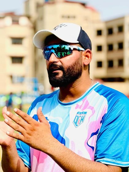 In discussion with players during the camp. Communication and clear instructions are key to effective coaching.