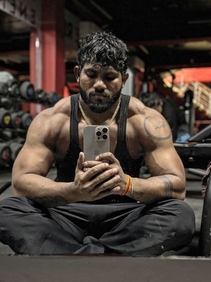 A moment of quiet reflection. Even in rest, the physique tells a story of hard work.