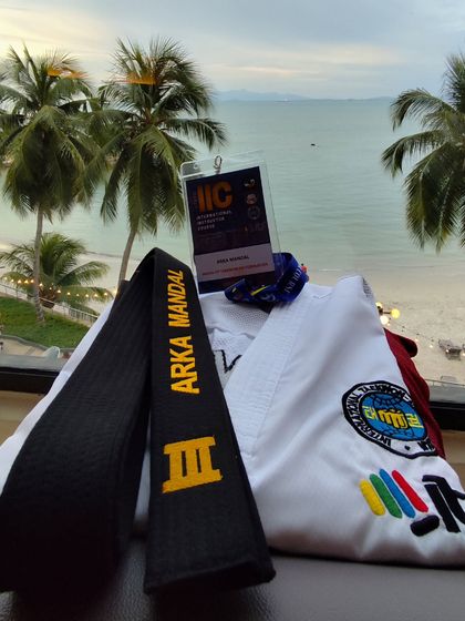 The tools of a martial artist: a dobok and a black belt, pictured against the scenic backdrop of Penang, Malaysia, after a rewarding International Instructor Course.