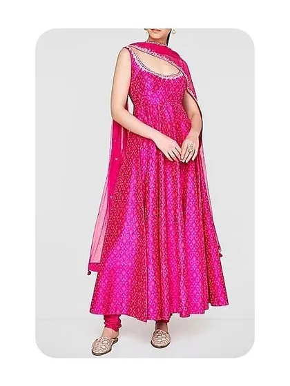 This is another example of a sleeveless Anarkali, here in a vibrant magenta. The custom-fitted bodice and flared skirt are designed to move beautifully, making it perfect for festive events.
