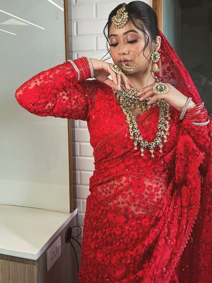 A series of a model in a beautiful red lace saree. This classic yet modern piece is versatile enough for a bridal trousseau shoot or a festive occasion.