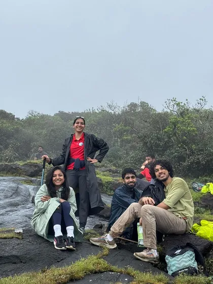 Trekkers taking a break on the misty trail of Kumara Parvatha.