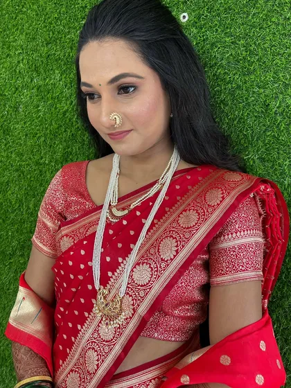 A close-up of the soft eye makeup and the traditional nath, perfect for an engagement ceremony.