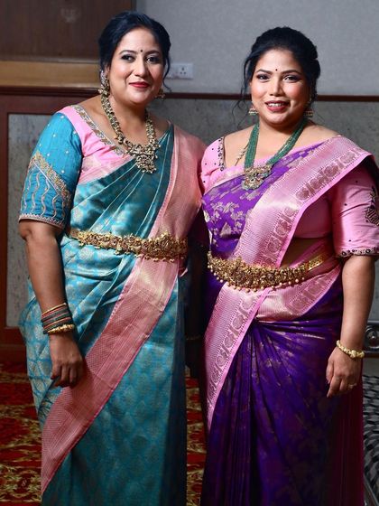 Our gorgeous clients look stunning in their respective pastel blue and royal purple Kanchipuram silk sarees.