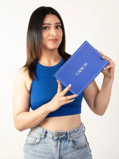 A smiling model presenting the product box, conveying customer satisfaction and brand trust.