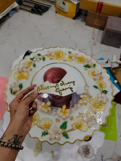 A work-in-progress shot of the large Guruji frame, with the "Blessings Always Guruji" text ready to be embedded in resin.