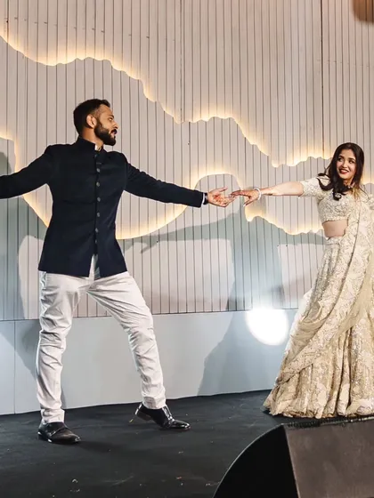 A candid moment of joy between the bride and groom during their sangeet dance. Our goal is to make you so comfortable with the steps that you can just enjoy the moment.