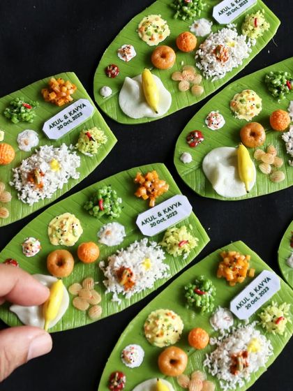 These personalized South Indian meal magnets were created as wedding return gifts, complete with the couple's name and wedding date.