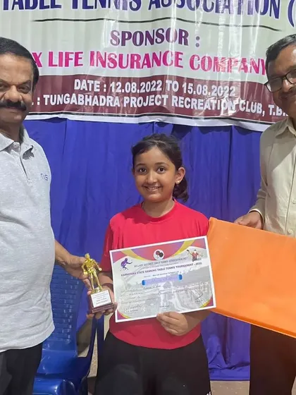 Raashi V receiving her award for reaching the semifinals in the U13 category at the Bellary tournament.