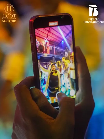A partygoer capturing the moment on their phone, a common sight at my gigs.