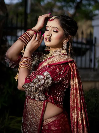 A dramatic pose highlighting the bride's eyes and the stunning details of her `Navari` saree and blouse.
