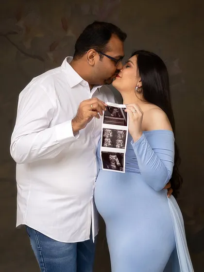 The first hello. Holding up the ultrasound photo is one of the most touching moments in a maternity session. It connects the love you feel now with the little person you can't wait to meet.