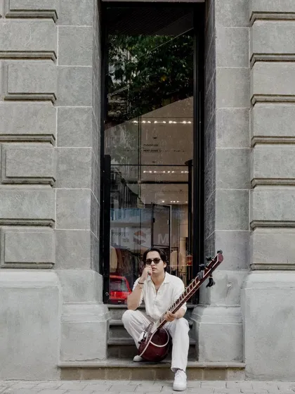 Sitting in a stone alcove, a modern artist in a classic setting.