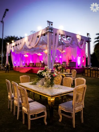 The 'Gardens of Europe' theme brought to life in Indore. This image captures the elegant outdoor dining setup against the backdrop of the grand stage, a perfect blend of nature and sophistication.