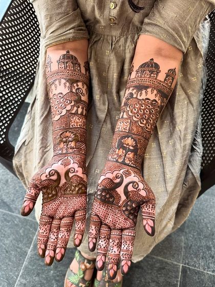 A front view of the same design, highlighting the peacock and jharokha motifs on the palms and forearms.