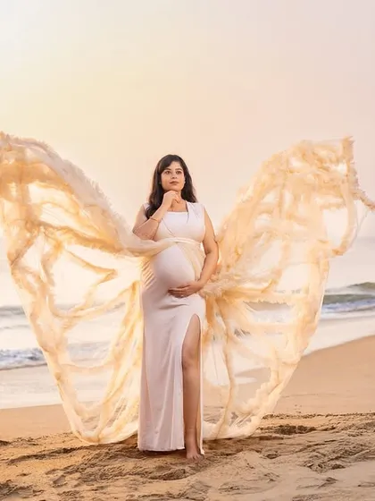 Like a scene from a dream, this butterfly gown in a soft cream color looks absolutely angelic against the sunrise. We help you choose the perfect gown to match the soft, magical light of a beach morning.
