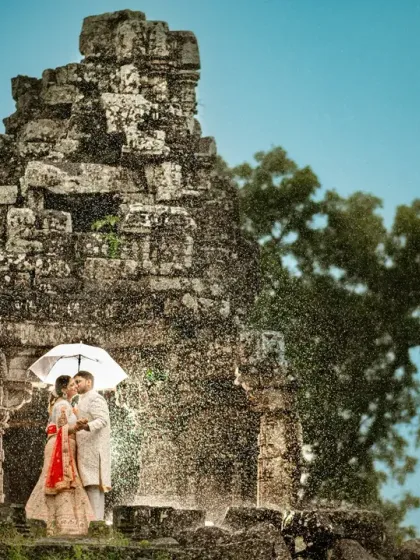 Embracing the rain during a post-wedding shoot in Nasik. Using an umbrella as a prop, we turned a downpour into a magical moment, with the ancient ruins providing a timeless backdrop.