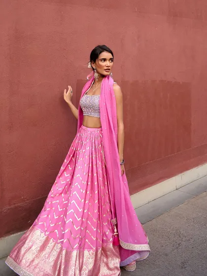 This vibrant pink lehenga from the Anam Cara collection is full of joy and movement. The gota patti work on the skirt adds a traditional touch to this modern silhouette.