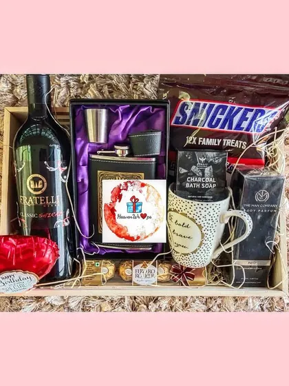 A sophisticated birthday hamper for him, combining a bottle of premium non-alcoholic wine with a stylish hip flask set, gourmet chocolates, and grooming essentials. It's the perfect blend of classic and modern.
