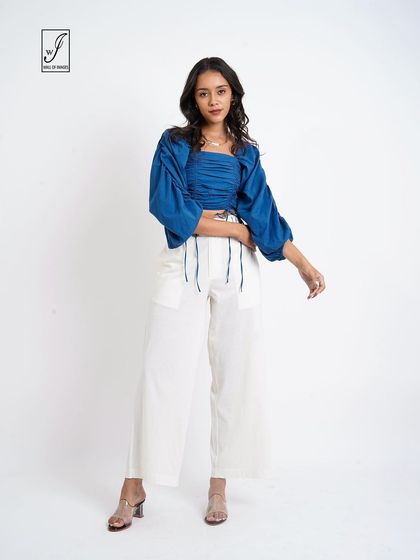 A full-length shot that provides customers with a clear view of the entire outfit's silhouette and proportions.