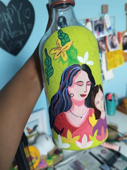 A work-in-progress shot of a Mother's Day bottle, showing the layers of paint coming together to form a beautiful portrait.