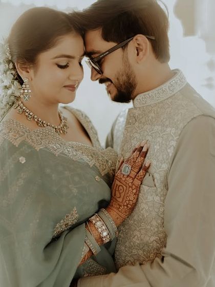 An intimate and emotional close-up of the couple. The soft lighting and their gentle embrace, combined with traditional attire, make this a powerfully romantic portrait.