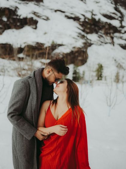 An almost-kiss moment, capturing the intimacy and romance of a pre-wedding shoot in the snow.