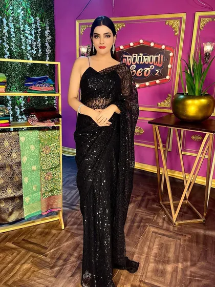 For a chic and modern look, this black sequin saree is a showstopper. It's perfect for cocktail parties, receptions, or any evening event where you want to sparkle and make a statement.