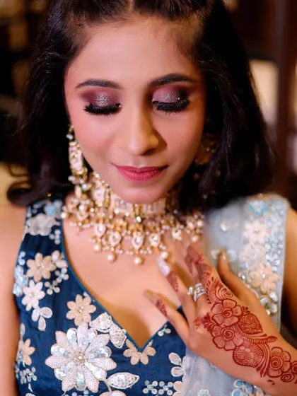 A close-up of my engagement makeup artistry. This look features a bold, glittery smokey eye with winged liner and full lashes, paired with a soft lip color to balance the dramatic eyes.