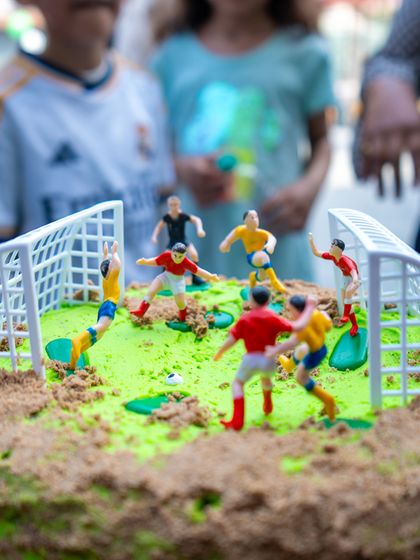 An incredibly detailed football cake, designed to look like a mini soccer pitch complete with players, was a highlight of the party.
