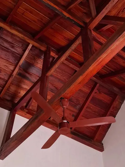 The exposed wooden truss system in a bedroom at the Basavanagudi house. We leave these structural elements visible to celebrate the natural beauty of the wood and the craftsmanship of the carpentry.