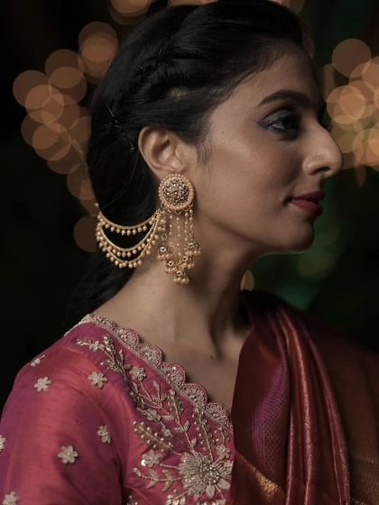 The Bahubali earring is a masterpiece of design, connecting the earring to the hair with delicate pearl chains. It’s a favorite for brides who want a look of royal elegance.