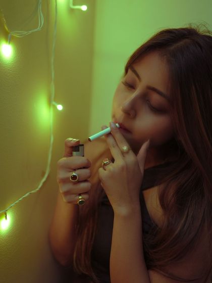 This portrait uses colored light and the act of smoking to create a cinematic, edgy mood. It's a great example of a styled, conceptual indoor shoot.