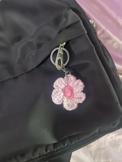 Here’s my two-toned flower keychain on a backpack. It adds such a cute, coquette vibe to a simple black bag.