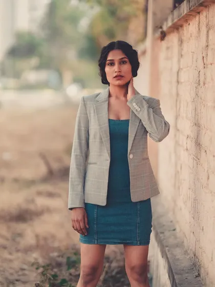 A chic and modern way to style a denim dress. Pairing it with a blazer gives it a sophisticated, street-style edge.